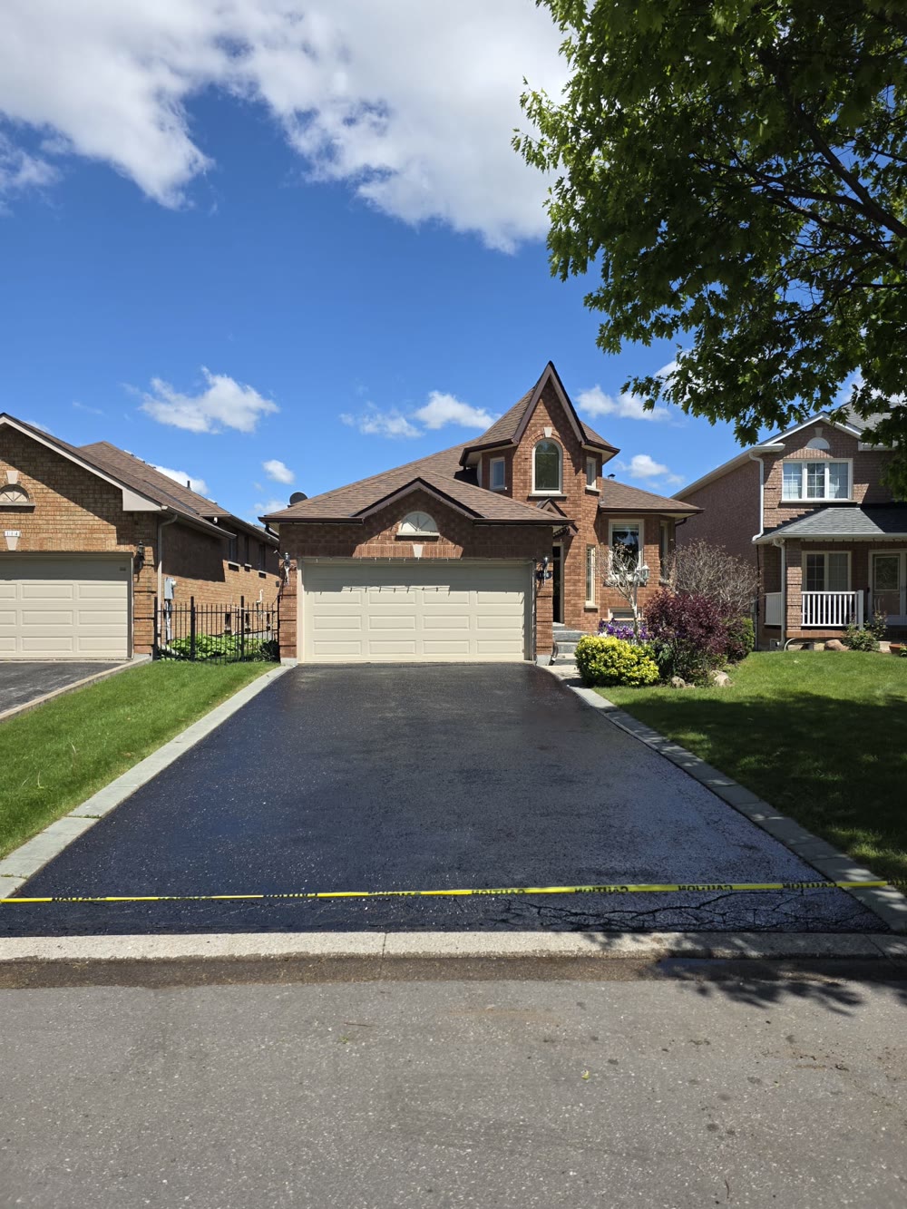 Sealed driveway at a brick home
